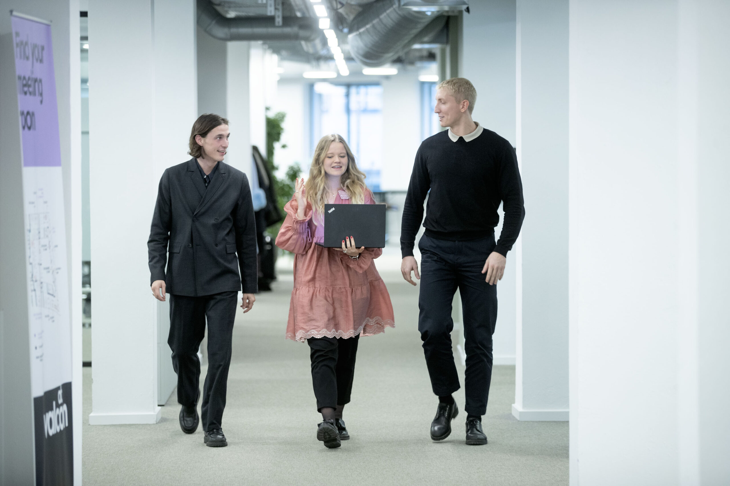 People walking in a office and discussing