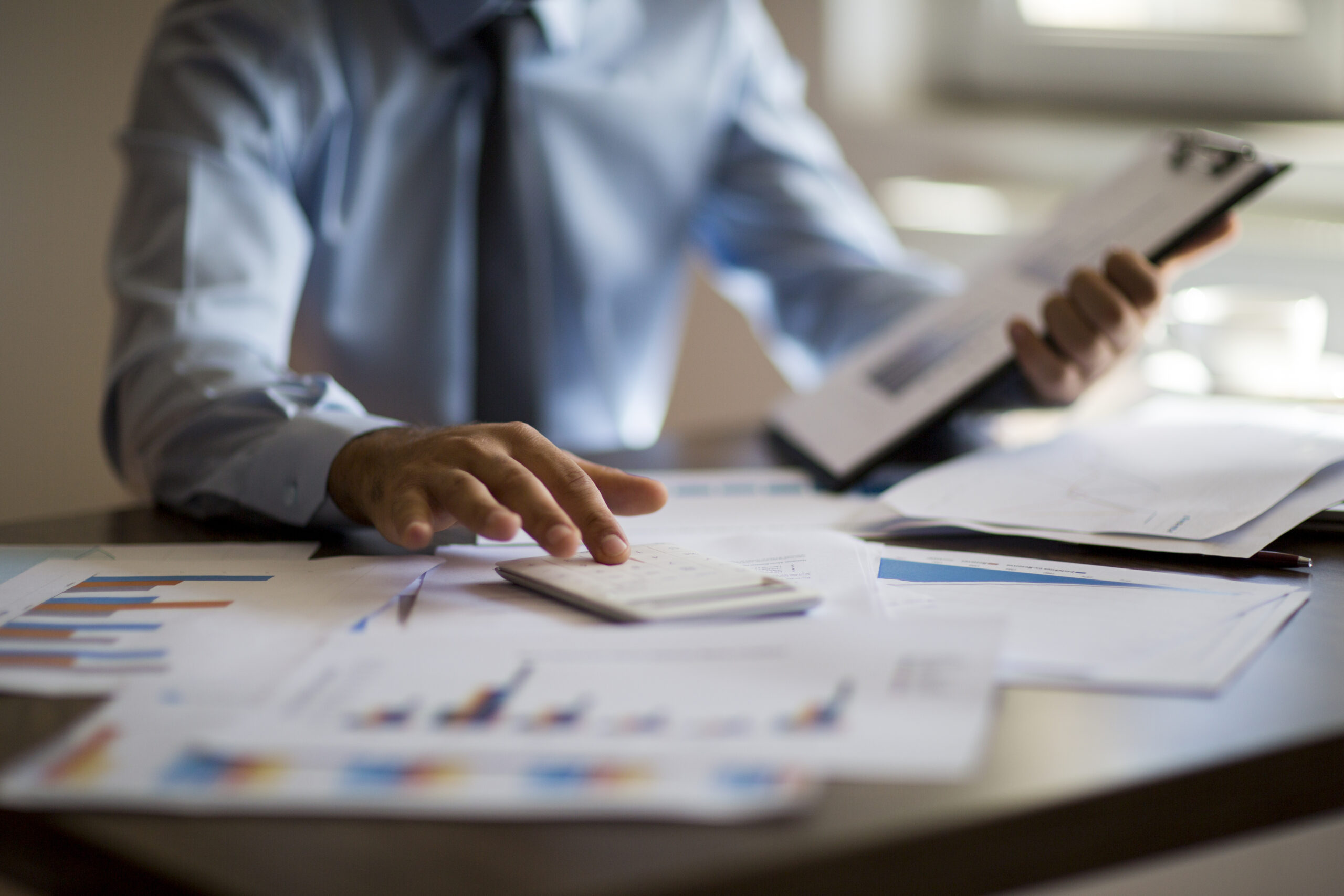 Public sector business man using calculator