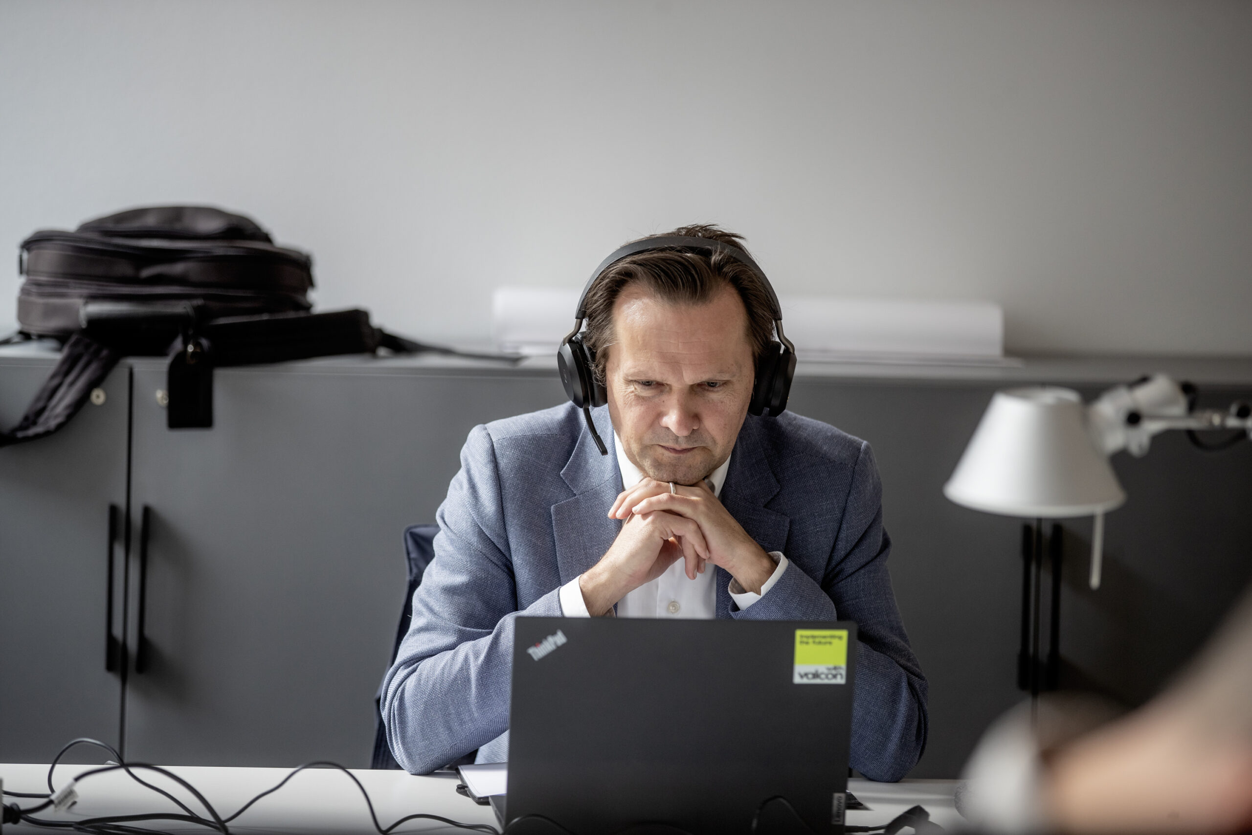 Man working on a laptop with headphones