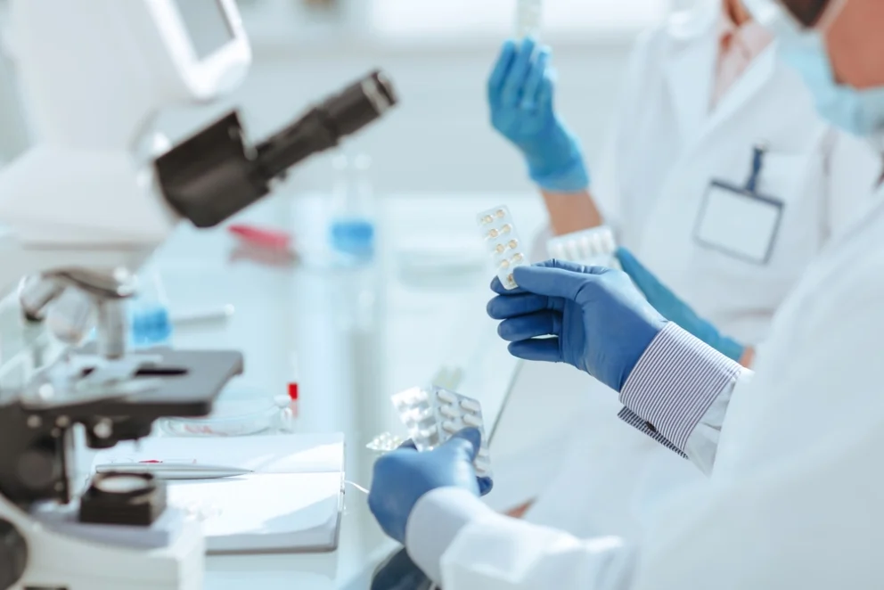close up of scientists in a lab testing a new drug